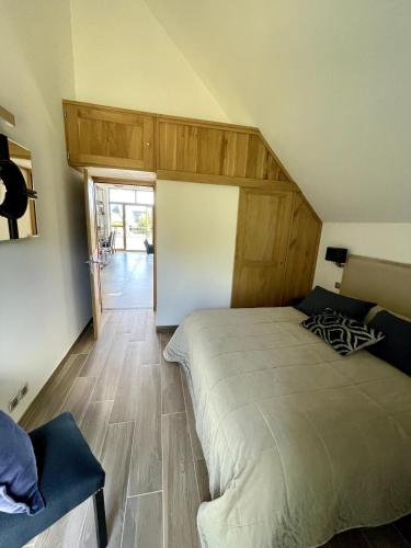 a bedroom with a large bed with a wooden headboard at Loft de Layolette, Laguiole centre, calme in Laguiole