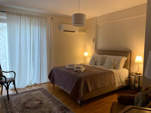 a bedroom with a bed with two towels on it at Luxury Maisonette with Pool in Pallíni