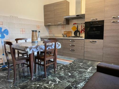 a kitchen with a table and chairs in a kitchen at Terrazza Dolce Vita in Levanto