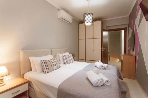 a bedroom with two white towels on a bed at Villa Afandou Bliss in Afantou