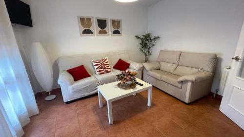 a living room with two couches and a table at La Paserina in Arenas de Cabrales
