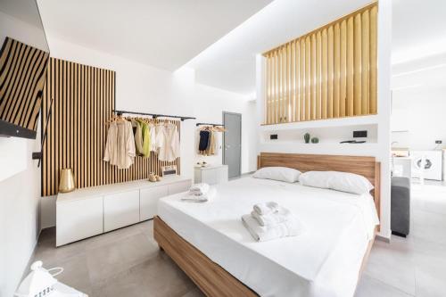 a bedroom with a large white bed in a room at Sole Apartments in Terracina