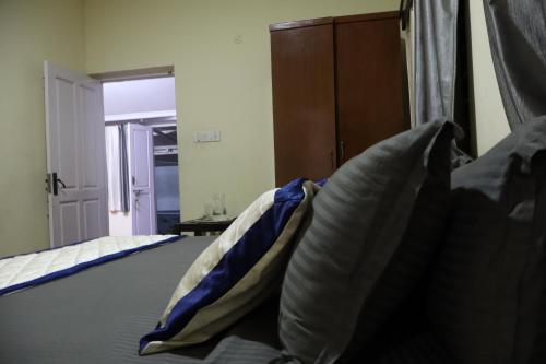 a bed with two pillows sitting on top of it at Bruton resorts in Kodaikānāl