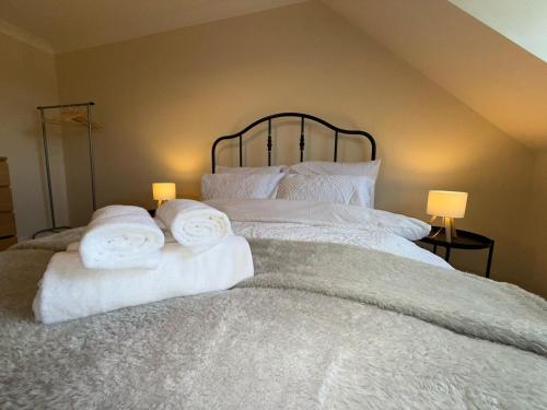 a bedroom with a bed with towels on it at Redhill Residential in Redhill