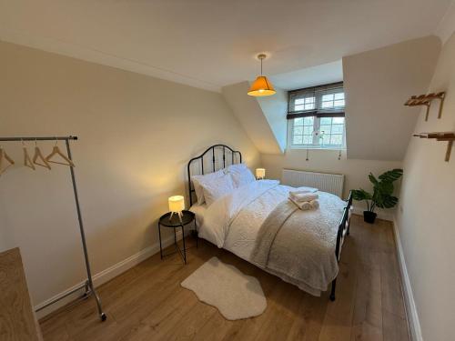 a bedroom with a bed and a window at Redhill Residential in Redhill
