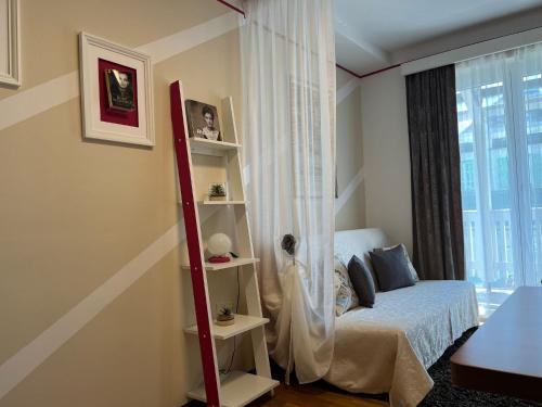 a bedroom with a bed and a book shelf at Gästehaus Gertrude in Velden am Wörthersee