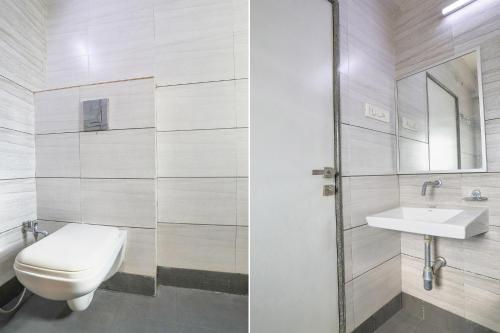 a bathroom with a toilet and a sink at FabHotel Balaji Inn - Panchwati in Nashik