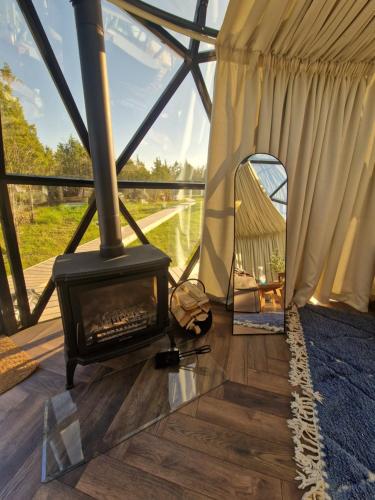 a room with a fireplace in a yurt at KUUL STAY - luxury domes in Virtsu