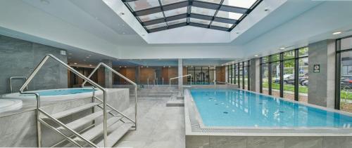 a large swimming pool in a building at Green Port ADMUS Apartments for Rent in Kołobrzeg