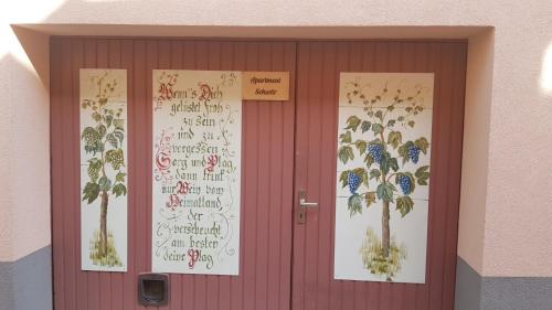 a red door with a bunch of writing on it at Apartment Schwär in Endingen