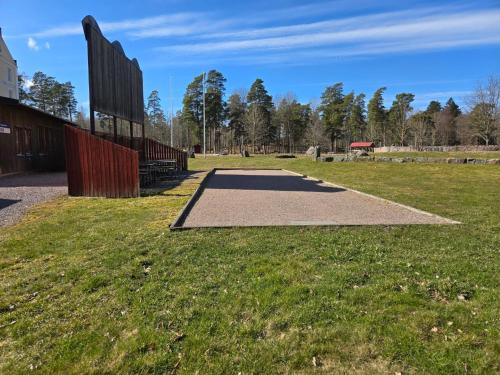 a path in a park with a grass field at Norrqvarn Hotel & Resort by Vänerport in Lyrestad