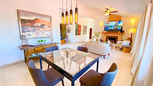 a living room with a glass table and chairs at Stunning Ajijic Lake Chapala 2 Bdrm Retreat -Bikes - Gym - Pickleball Court in Ajijic
