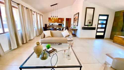 a living room with a couch and a table at Stunning Ajijic Lake Chapala 2 Bdrm Retreat -Bikes - Gym - Pickleball Court in Ajijic