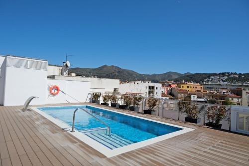 a swimming pool on the roof of a building at Hotel Marina in Roses