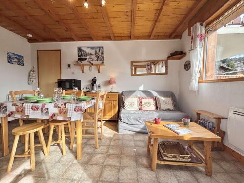 a kitchen and living room with a table and chairs at Appartement au pied des pistes avec terrasse, parking privé, casier à skis, proche commerces - FR-1-595-75 in Crest-Voland