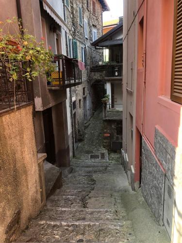 an alley in an old town with buildings at La Ballerina Bianca - romantica vista lago in Bellano
