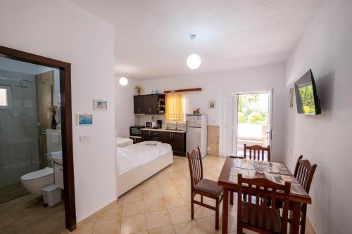 a living room with a dining table and a kitchen at Cozy Apartments Downtown in Ksamil