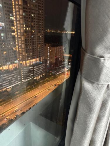 a view of a city at night from a window at Jac Urban Suites Luxury & Premium Staycation 10pax in George Town