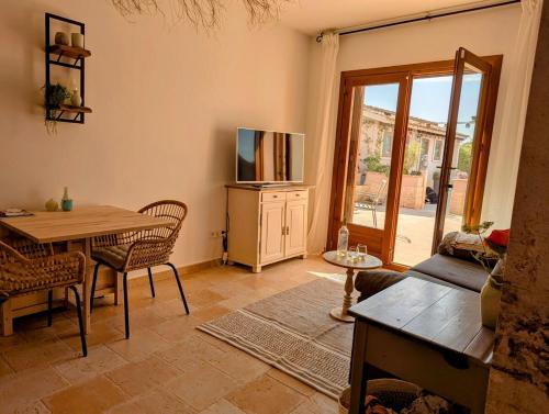 a living room with a table and a tv at Villa Oasis in Vera