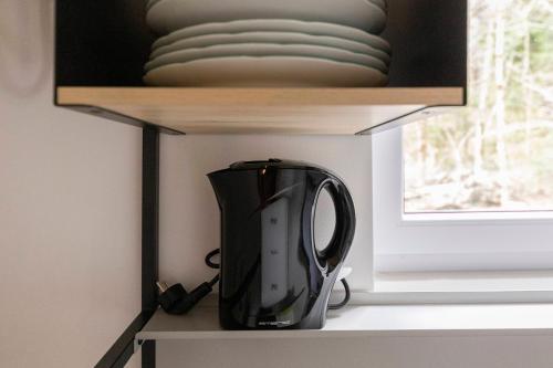 a black blender sitting on a shelf in a room at Unique Forest Lodge Bled in Bled