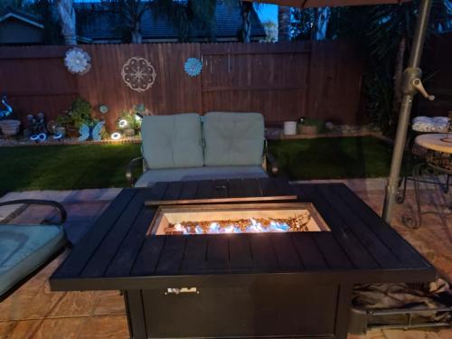a fire pit in the middle of a patio at Buena Vista home in Visalia