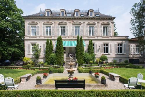 a large building with a clock on the front of it at Hotel Belle Epoque in Baden-Baden