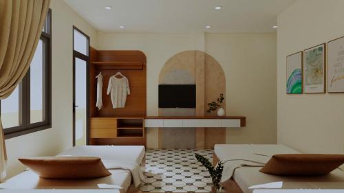 a living room with two beds and a tv at SKY Homestay in Hue