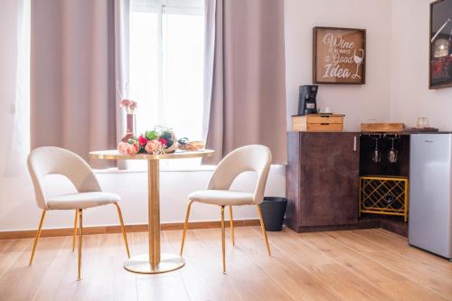 a dining room with a table and two chairs at Halanus Agriexperience in Alanno