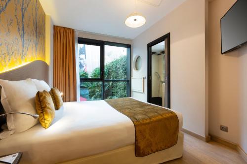 a bedroom with a large bed and a large window at Hôtel Hor Europe in Paris