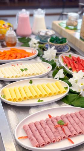 a table topped with plates of food on top at Portal Da Praia Hotel in Fortaleza