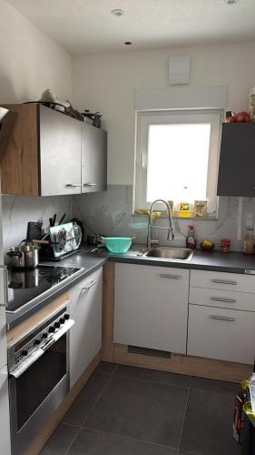 a kitchen with a sink and a stove top oven at Bifi 55 in Aalen