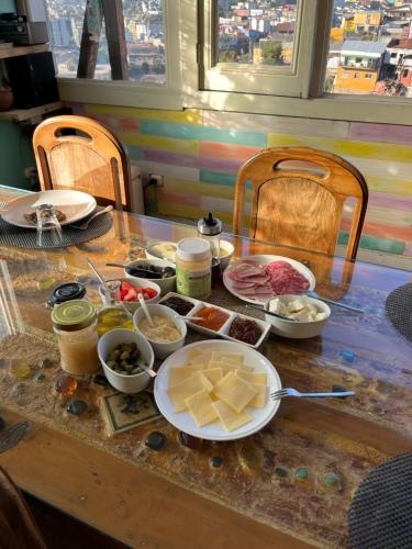 a table with plates of food on top of it at BbCasita Yellow in Valparaíso