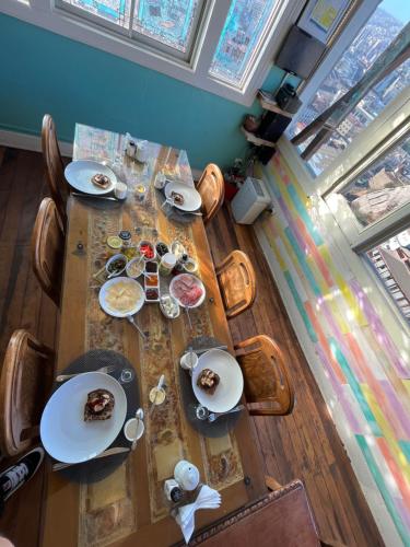 a wooden table with plates of food on it at BbCasita Yellow in Valparaíso
