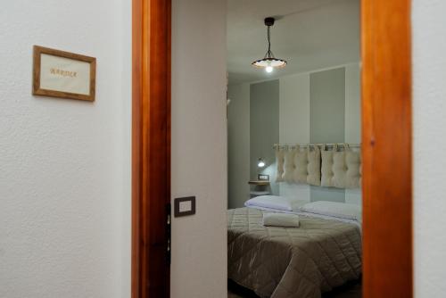 a room with a bed in a room with a mirror at B&B Tiscali in Dorgali