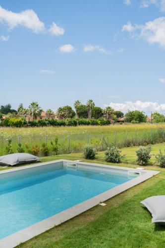 a swimming pool in the yard of a house at Sevene Villas - Kourouta Peloponnese in Petroúlai