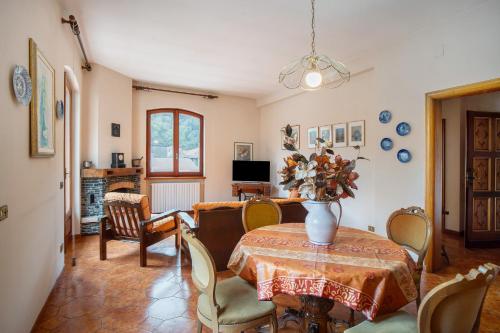 a dining room with a table with a vase on it at Casa Lilli in Pieve di Teco