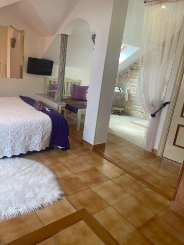 a bedroom with a bed and a living room at Hosteria Las Fuentes in Rubayo