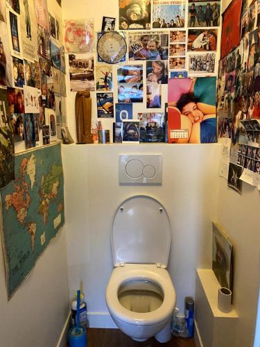 La salle de bains est pourvue de toilettes avec des photos murales. dans l'établissement Couronnes 2 bis - CI - Apartment 55m2 Paris Couronnes with balcony, à Paris