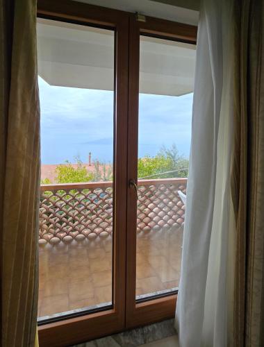 a sliding glass door with a view of a balcony at Hotel Il Nido Sorrento in Sorrento