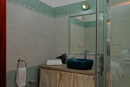a bathroom with a sink and a mirror at B&B Tiscali in Dorgali