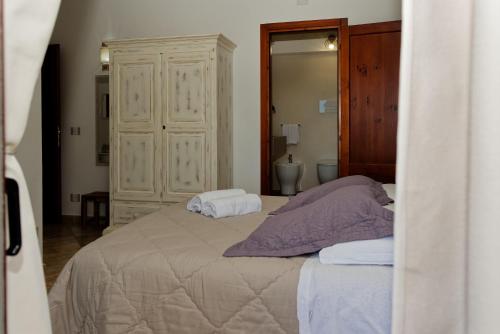 a bedroom with a bed with two towels on it at B&B Tiscali in Dorgali