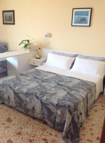 a large bed in a bedroom with a bed sidx sidx sidx at Hotel David in Cesenatico