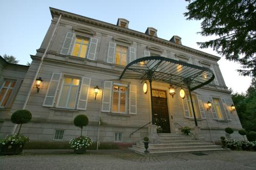 a large white house with a door and stairs at Hotel Belle Epoque in Baden-Baden