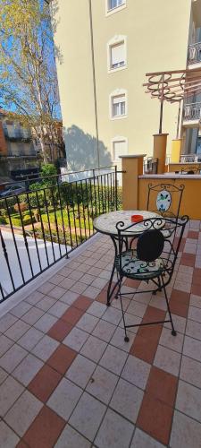 a table and a chair sitting on a patio at Hotel Alibi in Rimini