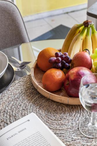 a plate of fruit on a table with a glass of wine at Modern Stay I Cosy & Central Apartments in Koblenz