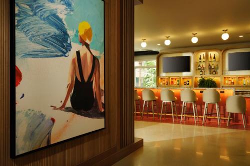a painting of a woman in a black dress on a wall at Residence Inn by Marriott Miami Beach Surfside in Miami Beach