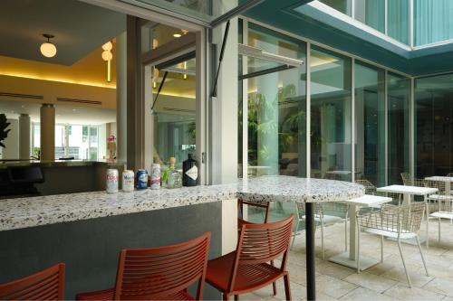 a bar with chairs and a table in a restaurant at Residence Inn by Marriott Miami Beach Surfside in Miami Beach