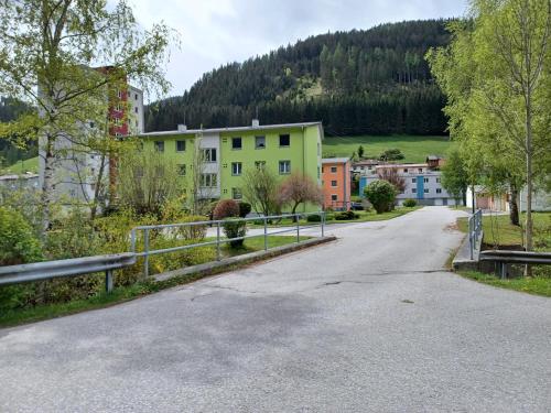 an empty street in a small town with buildings at Bergmann Apartment Veitsch in Niederaigen
