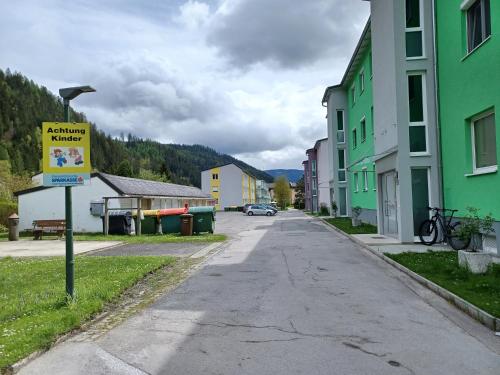 an empty street in a small town with buildings at Bergmann Apartment Veitsch in Niederaigen