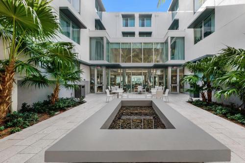 a building with a fountain in the middle of a courtyard at Residence Inn by Marriott Miami Beach Surfside in Miami Beach